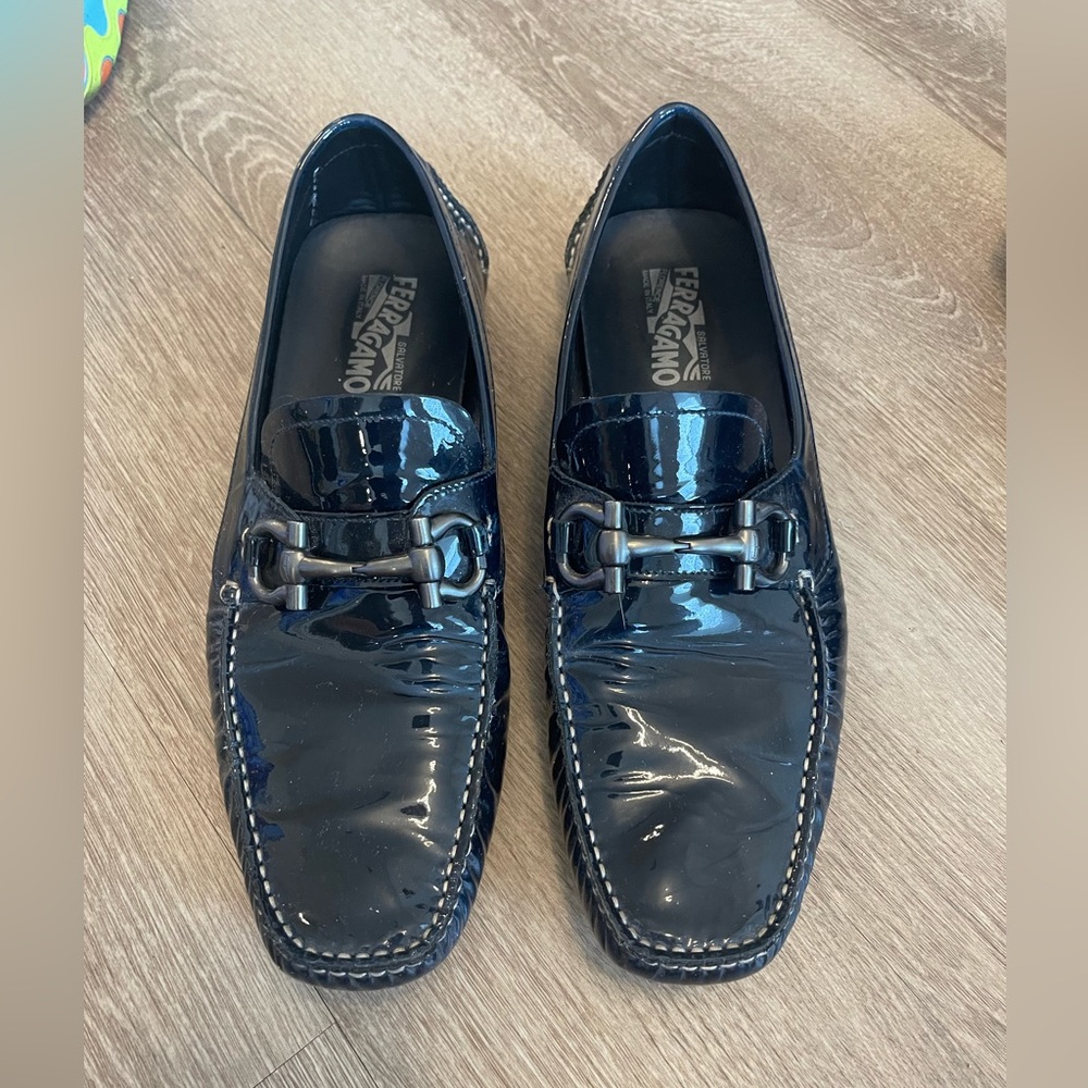 Salvatore Ferragamos black vinyl loafers